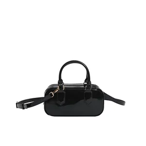 Glossy black PVC jelly pillow bag with top handles and adjustable shoulder strap