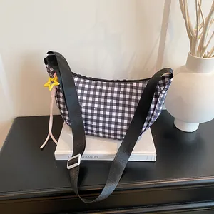 Checkered moon bag with black and white grid pattern and star charm accessory