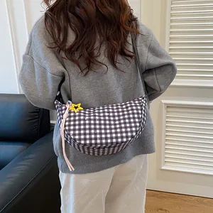 Plaid crescent crossbody bag for women featuring a star pendant and tassel on the strap