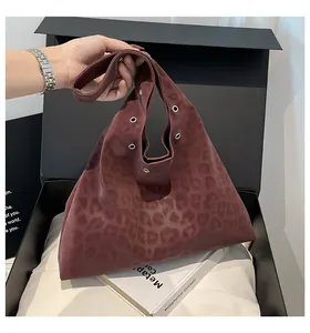 Detail of burgundy leopard print hobo bag with metallic eyelets in a premium gift box