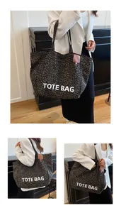 Macro detail of leopard print canvas tote with white TOTE BAG text and leather tag