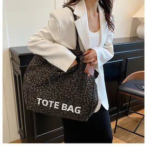 Detailed macro view of leopard print canvas fabric with white TOTE BAG text print