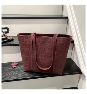 Detailed close-up of dark red leopard print tote bag with high-capacity design and slim straps