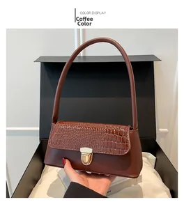 Brown baguette shoulder bag with crocodile embossing and gold lock in a gift box