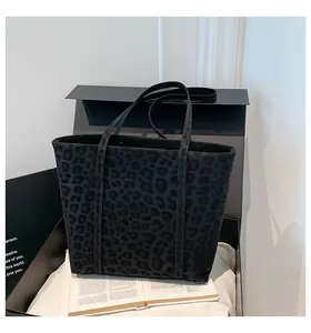 Macro shot of black leopard print tote bag with soft texture in premium gift box