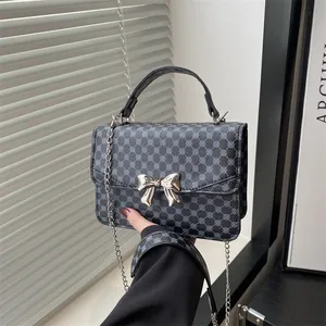 Deep grey-blue fashion crossbody bag with silver bow buckle and geometric pattern