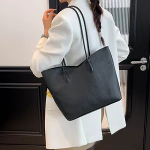Large black tote bag in lychee leather grain for daily commute with slim shoulder straps