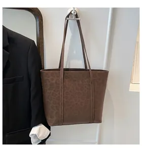 Detail of vintage leopard print tote bag with spacious interior and slim shoulder straps