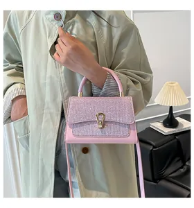 Detail of pink crossbody bag with sparkling sequins and gold hardware on model