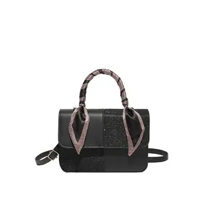 Black patchwork shoulder bag with tweed texture and silk scarf wrapped handle