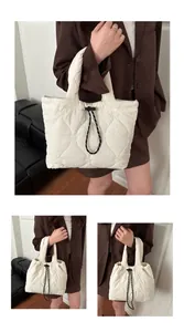 Close-up of heart-shaped quilted stitching and black-and-white drawstring on white tote bag