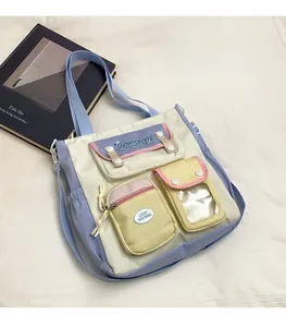 Detail view of multi-pocket pastel school bag with transparent PVC window and adjustable strap