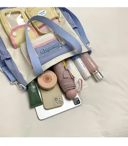 Detail view of multi-color canvas shoulder bag showing spacious storage for tablet and makeup