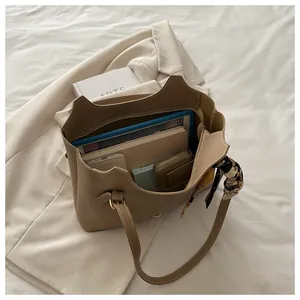 Interior view of khaki tote bag showing large capacity for tablet and daily items