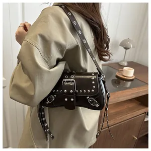 Deep brown leather shoulder bag featuring vintage silver studs and adjustable belt straps