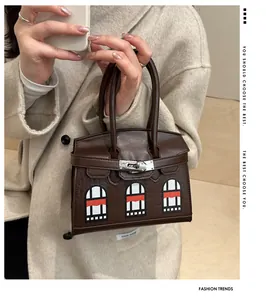 Detail of crocodile embossed leather handbag with creative architectural window design