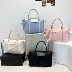 Large capacity travel duffel bags in blue pink cream and black with adjustable straps