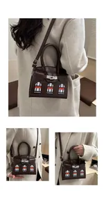 Detail view of the brown crocodile leather luxury handbag with iconic window design