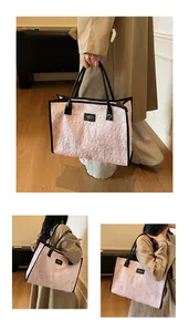 Detail of pink quilted tote bag featuring multi-colored wavy stitching and black handles