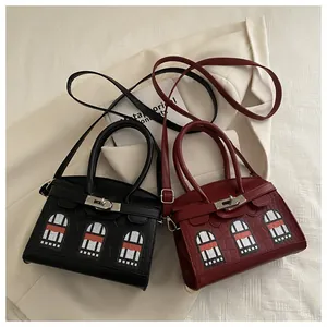 Detail view of mini handbags with crocodile pattern and house window applique designs