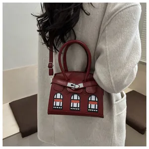 Detailed view of dark red faux crocodile leather handbag with unique window patterns