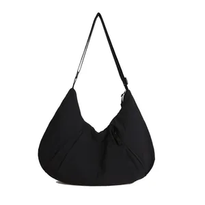 Large black nylon crescent dumpling bag with pleated detail and adjustable strap