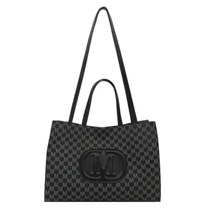 Fashion black tote bag with gray M-letter print and large embossed logo on white background
