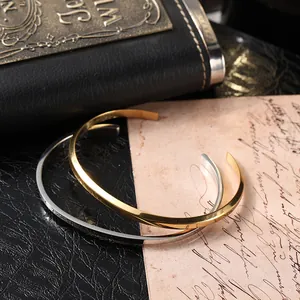 Detailed view of gold and silver Mobius twist open bangles on vintage paper