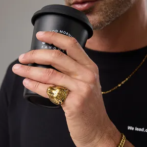 Vintage golden tiger head ring for men in retro punk style shown on model holding a cup
