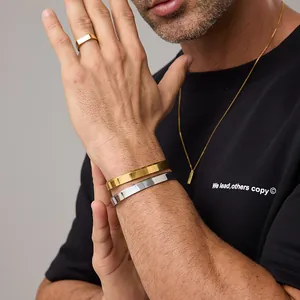 Detailed set of minimalist gold rings, bangles, and a pendant necklace on a model