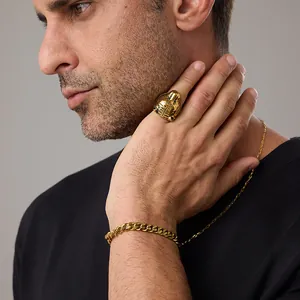Detail of vintage gold tiger head ring with matching cuban chain bracelet on model