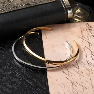 Minimalist open titanium steel bangle in gold and silver finish with flat geometric design