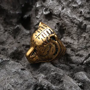 Detailed macro view of vintage gold tiger head ring with intricate punk engraving