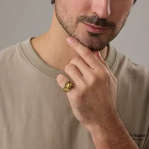 Vintage gold wolf head ring with Viking engravings worn by male model on little finger