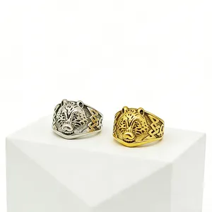 Detailed view of vintage wolf head steel rings with Celtic knot engravings in silver and gold