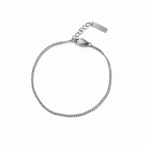 Minimalist 18K gold curb chain bracelet with adjustable lobster clasp and metal tag