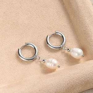 Detailed close-up of 14K gold plated hoop earrings with natural freshwater pearls