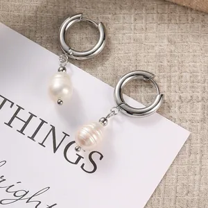 Detail of 14K gold plated hoop earrings with natural freshwater baroque pearl pendants