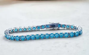 Close-up of S925 sterling silver tennis bracelet with sea blue moissanite stones