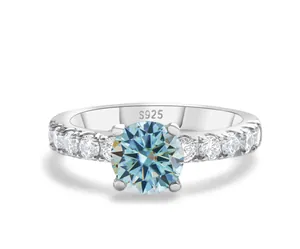 Detailed view of S925 sterling silver stamp on blue moissanite four-prong ring