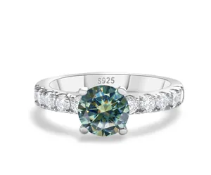Close-up of S925 sterling silver ring with blue-green moissanite and pave accents