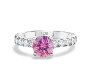 Close-up of pink moissanite stone set in S925 sterling silver four-prong ring detail