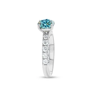 Macro view of S925 sterling silver ring featuring a blue moissanite and engraving