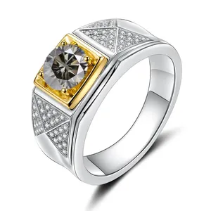 Detail of a two-tone 925 silver ring featuring a round moissanite in a gold square setting