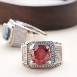 Detailed close-up of S925 silver rings with large red and blue round cut moissanite stones