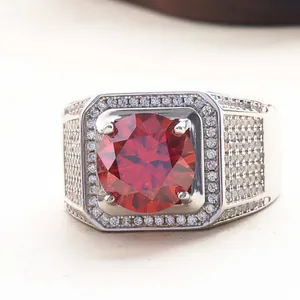 Macro shot of 5 carat red stone ring with halo setting and pave diamond band