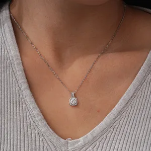 Macro shot of 925 sterling silver square halo pendant necklace worn by a female model