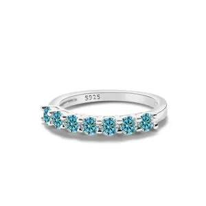Detailed shot of 925 sterling silver band with seven sparkling blue moissanite stones