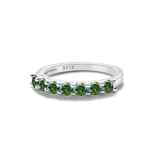 Detail of 925 sterling silver stamp and seven round green moissanite stones on the band
