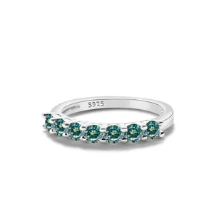 Macro shot of S925 sterling silver ring with seven prong-set blue-green gemstones